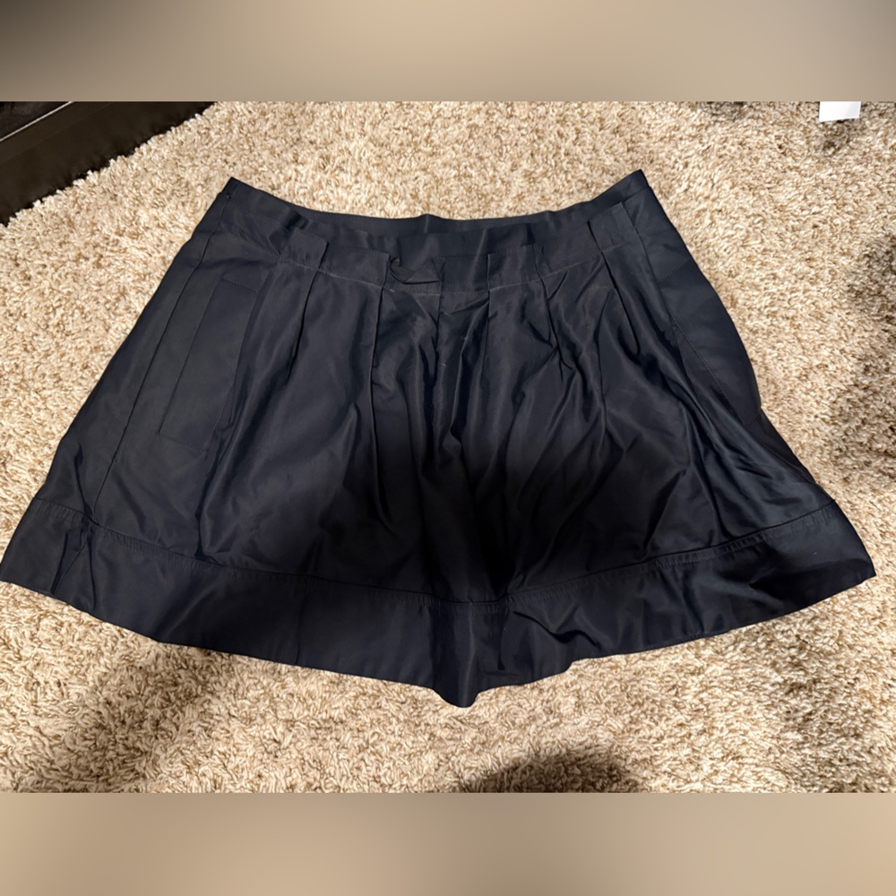 Black Express pleated mini skirt with pockets.